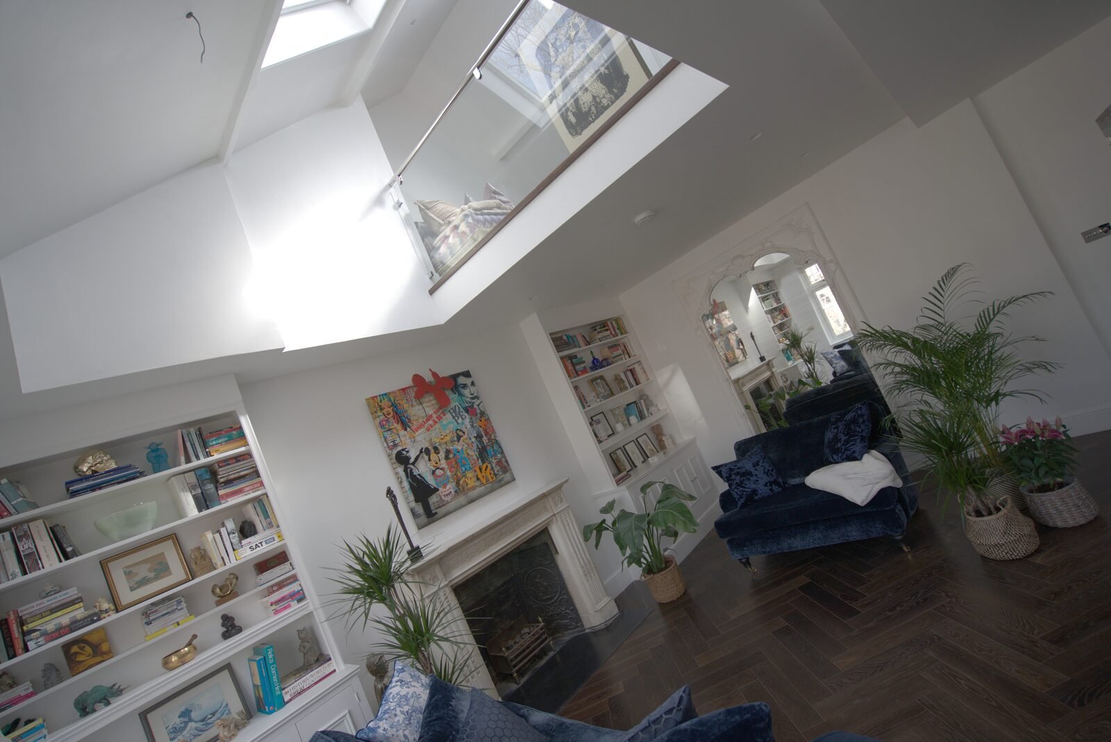 Open-plan living space with parquet flooring and a glass-balustrade mezzanine, Earls Court duplex refurbishment